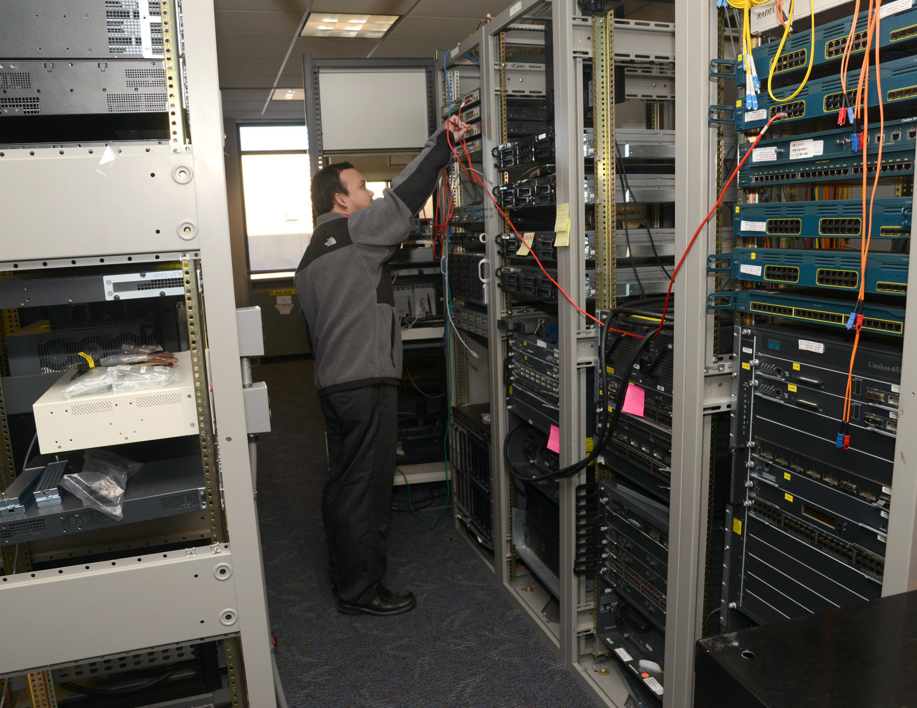 IT Tech working on a server stack