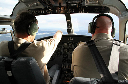 Pilot and Copilot sitting in the cockpit of a flying plane