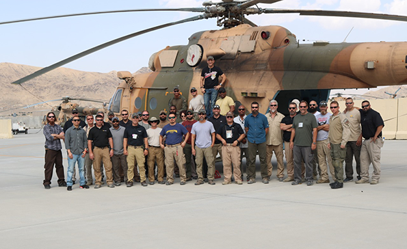 Kabul Team in front of a helicopter